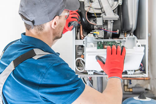HVAC Technician working on furnace