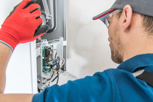 HVAC Technician fixing furnace